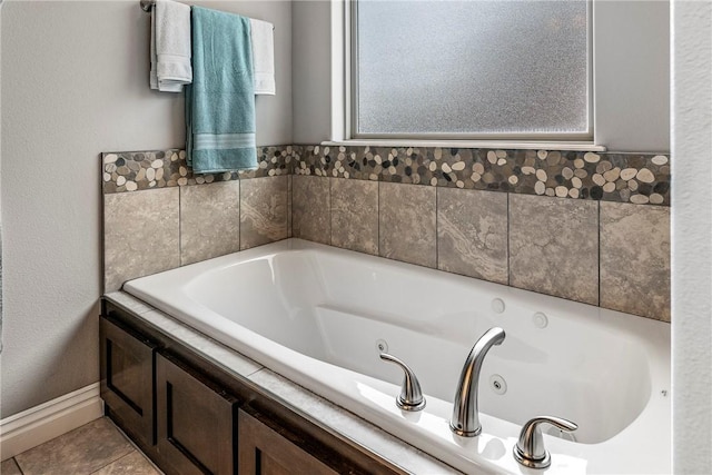 bathroom with a relaxing tiled tub and tile patterned flooring