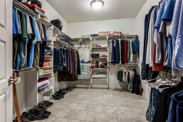 walk in closet with light tile patterned floors