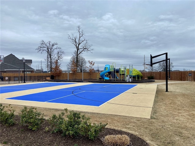 view of sport court featuring a playground