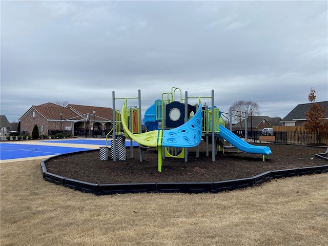 view of playground with basketball hoop