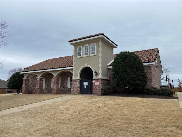 mediterranean / spanish house with a front lawn