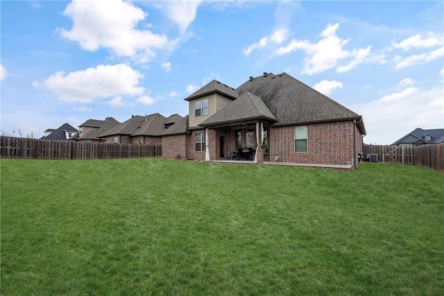 rear view of house with a lawn