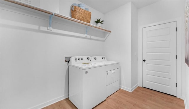 washroom featuring independent washer and dryer and light hardwood / wood-style flooring