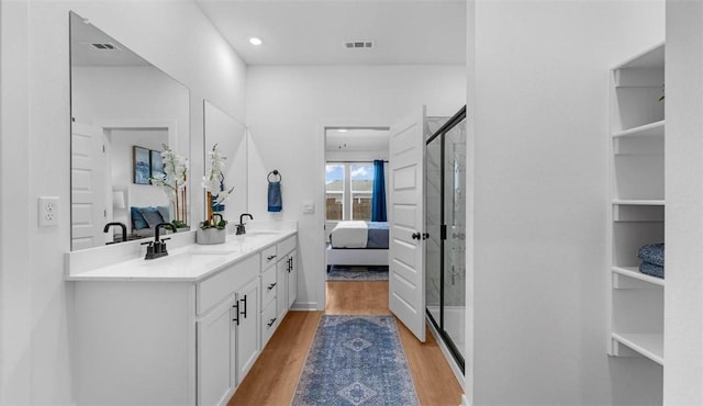 bathroom with vanity, hardwood / wood-style floors, and walk in shower