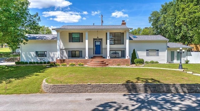 raised ranch featuring a front yard