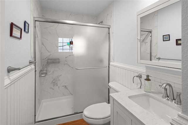 bathroom with vanity, toilet, and walk in shower