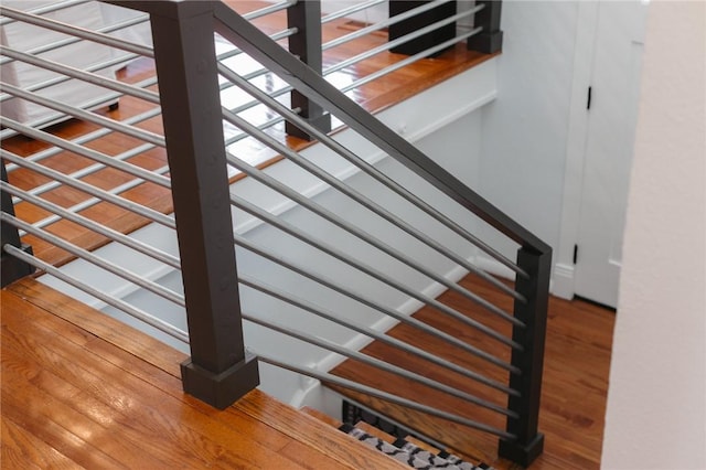 stairs featuring hardwood / wood-style flooring