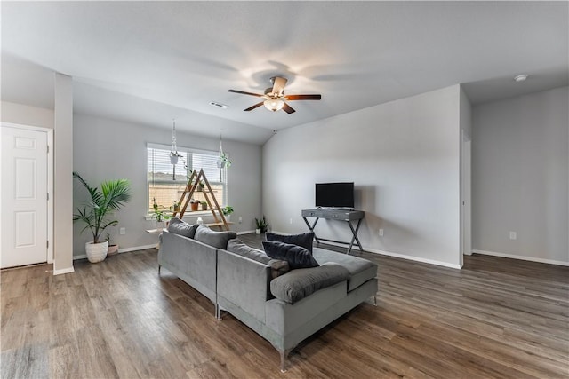 living room with dark wood-type flooring, ceiling fan, and vaulted ceiling