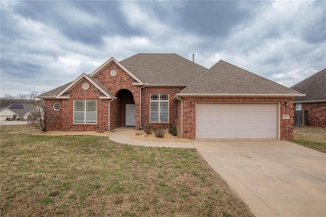 ranch-style house featuring a garage and a front lawn