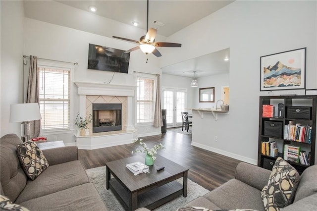 living room featuring french doors, a high end fireplace, hardwood / wood-style floors, and a wealth of natural light