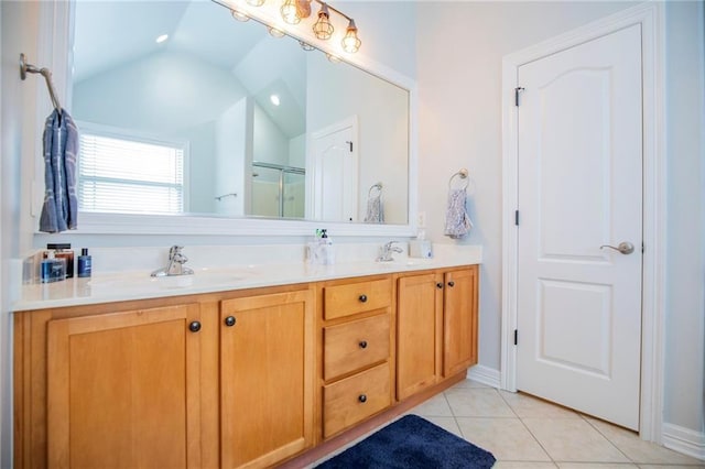 bathroom featuring vanity, vaulted ceiling, tile patterned floors, and walk in shower