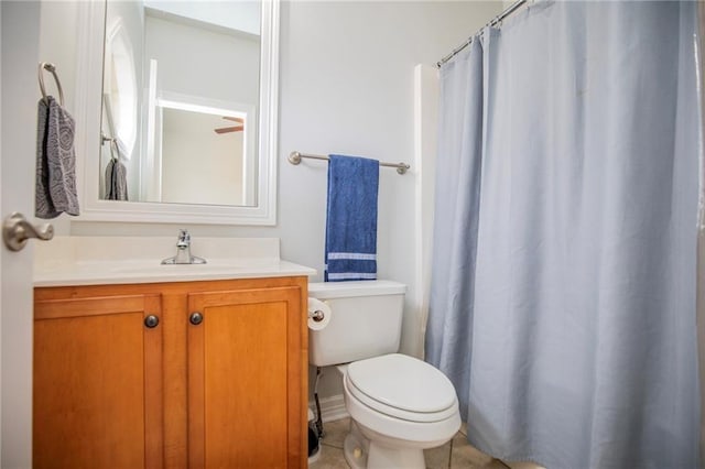 bathroom featuring vanity, tile patterned flooring, and toilet