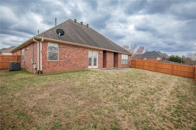 back of house featuring french doors, a patio area, a lawn, and cooling unit