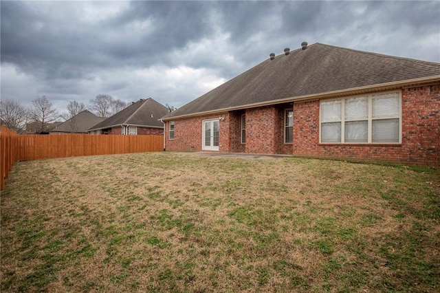 back of house with a lawn