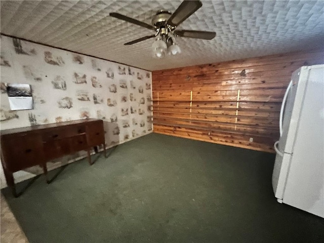 interior space featuring ceiling fan and carpet