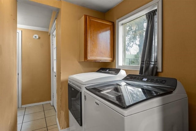 laundry area featuring light tile patterned floors and washing machine and clothes dryer