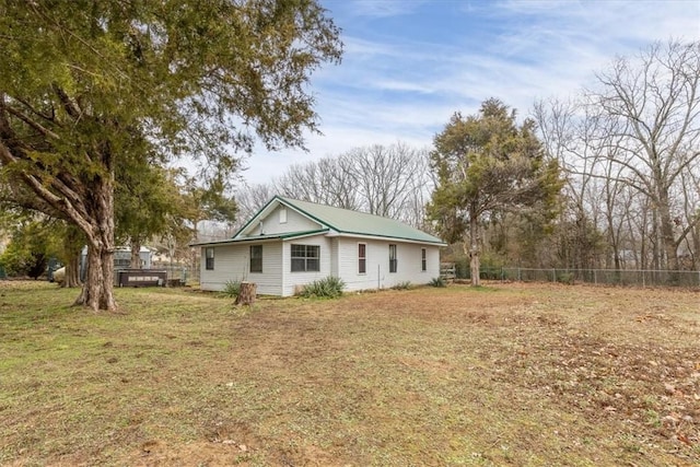 view of property exterior with a lawn