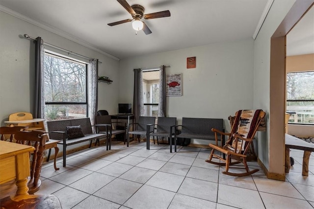 living area with plenty of natural light, light tile patterned floors, and ceiling fan