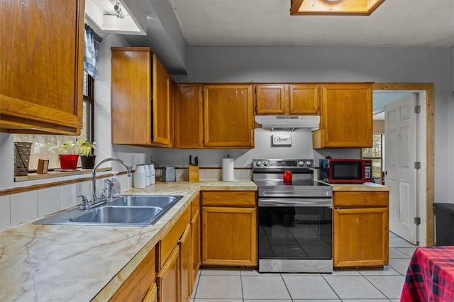 kitchen with sink, stainless steel electric range, and light tile patterned flooring