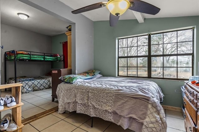 tiled bedroom with beamed ceiling and ceiling fan