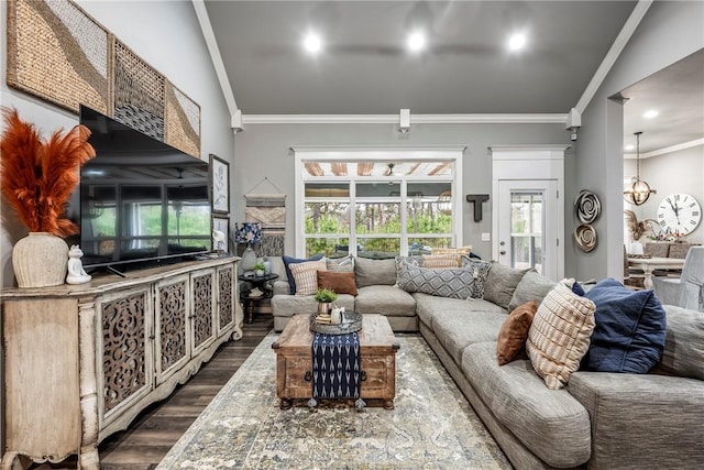 living room with ornamental molding, wood-type flooring, and a notable chandelier