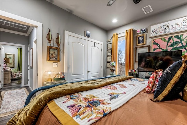 bedroom with crown molding and a closet