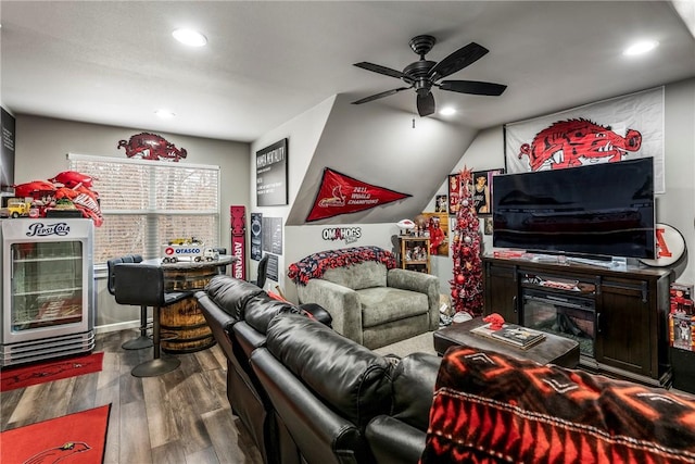 living room with hardwood / wood-style flooring, heating unit, and ceiling fan