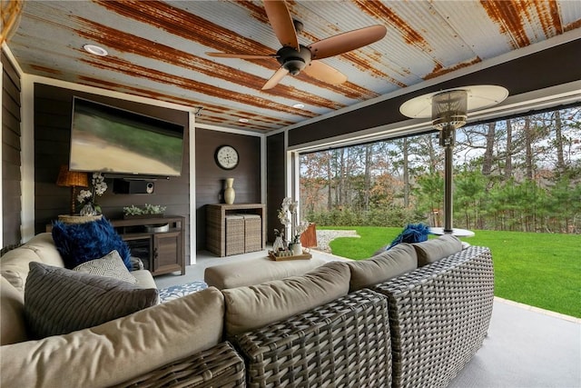 sunroom / solarium featuring ceiling fan