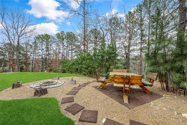 view of patio featuring a playground and an outdoor fire pit