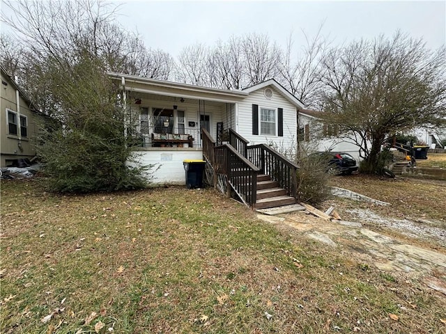 view of front of house featuring covered porch and a front yard