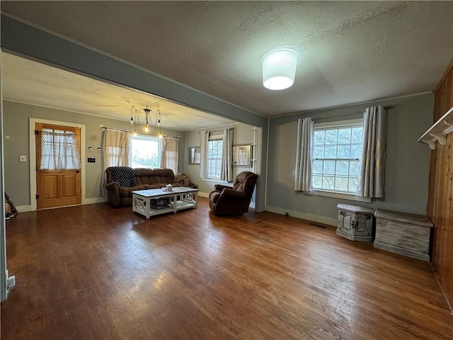 unfurnished living room with a textured ceiling and dark hardwood / wood-style flooring