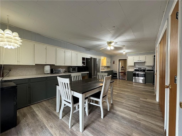 dining space with hardwood / wood-style floors and ceiling fan