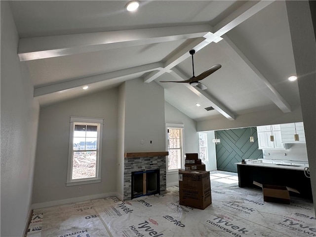 unfurnished living room featuring ceiling fan, a fireplace, beam ceiling, and high vaulted ceiling