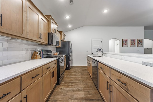 kitchen with stainless steel appliances, tasteful backsplash, visible vents, vaulted ceiling, and a sink