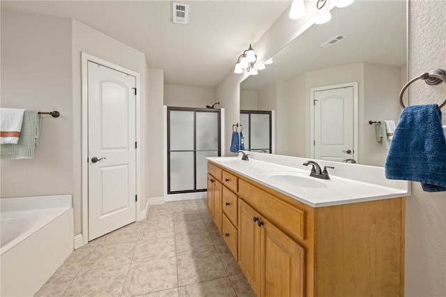 bathroom with tile patterned flooring, vanity, and separate shower and tub