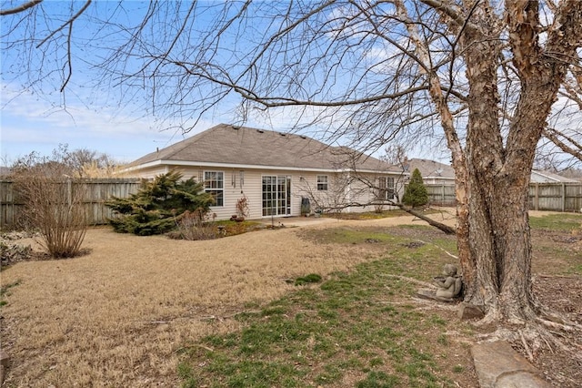 rear view of house with a patio area and a lawn