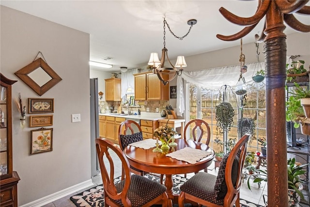 tiled dining space featuring a chandelier