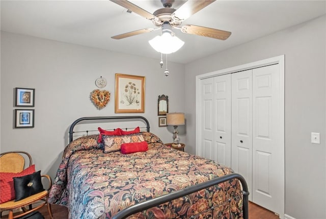 bedroom with ceiling fan and a closet