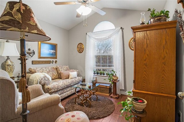 living room with ceiling fan, wood-type flooring, and vaulted ceiling