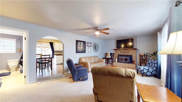 carpeted living room with ceiling fan