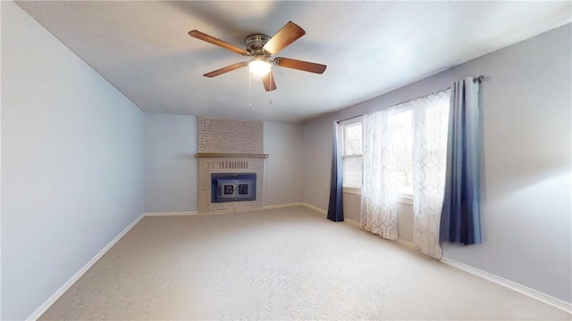 unfurnished living room with ceiling fan, light carpet, and a brick fireplace