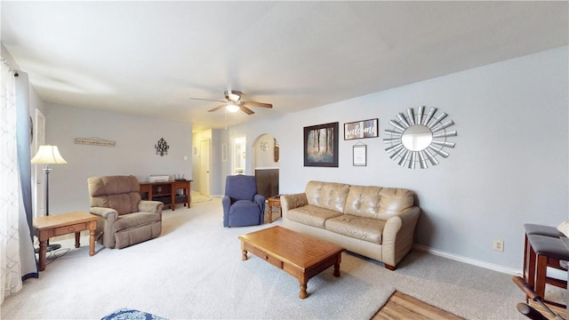 carpeted living room with ceiling fan