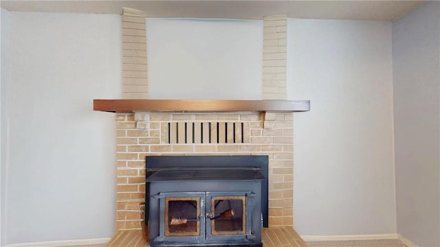 interior details with carpet floors and a wood stove