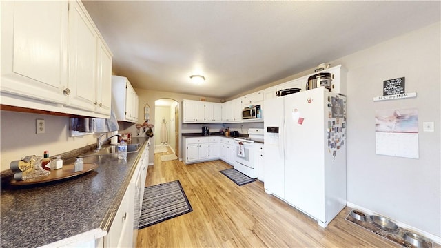 kitchen featuring white appliances, sink, light hardwood / wood-style flooring, and white cabinets