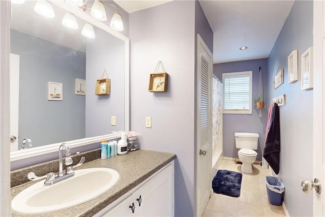 bathroom with tile patterned floors, vanity, and toilet