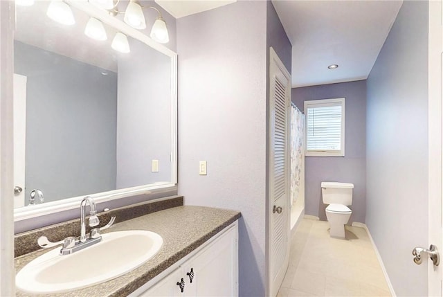 bathroom featuring vanity, tile patterned floors, and toilet