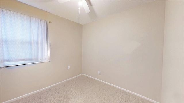 carpeted empty room featuring ceiling fan