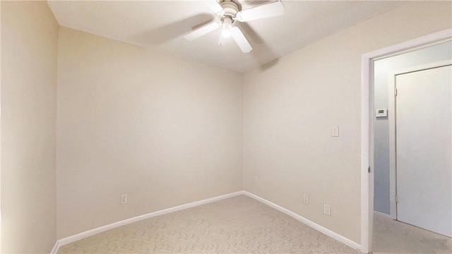 empty room featuring light carpet and ceiling fan