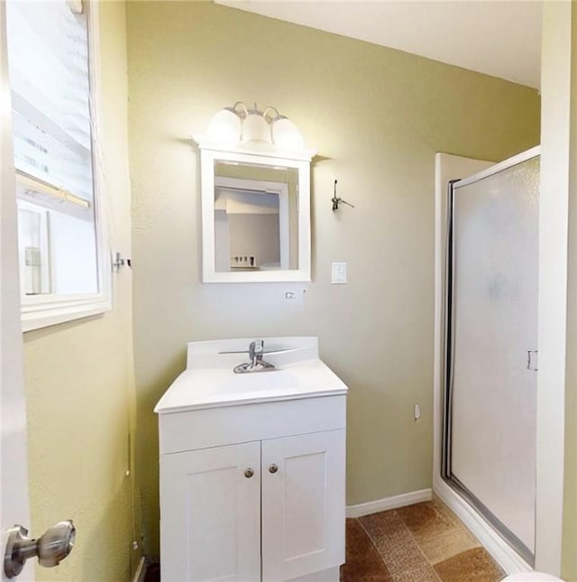 bathroom with vanity and a shower with shower door