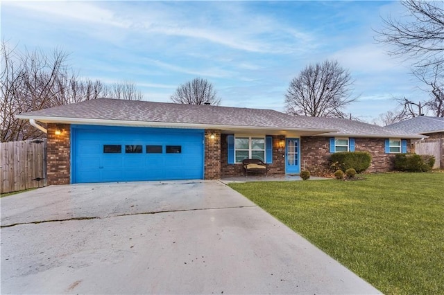 single story home featuring a garage and a front lawn